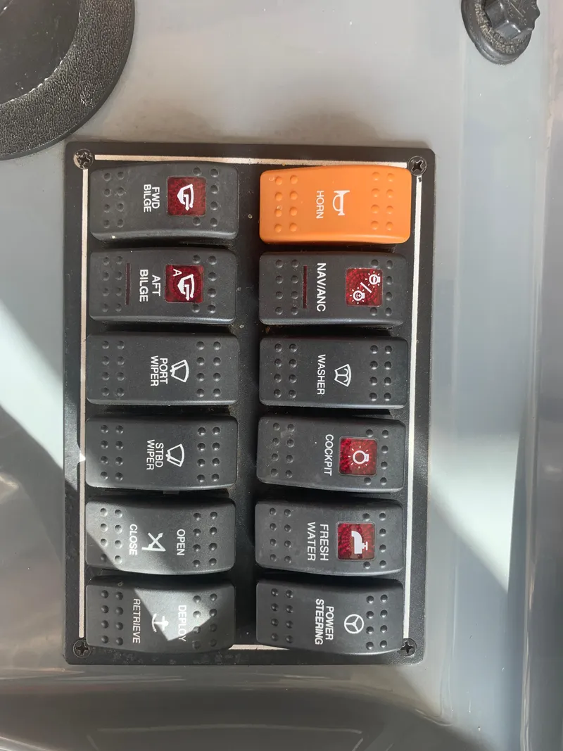 Slide: The Image of Control panel of a 2008 Pursuit 315 OS boat with labeled switches. - 8