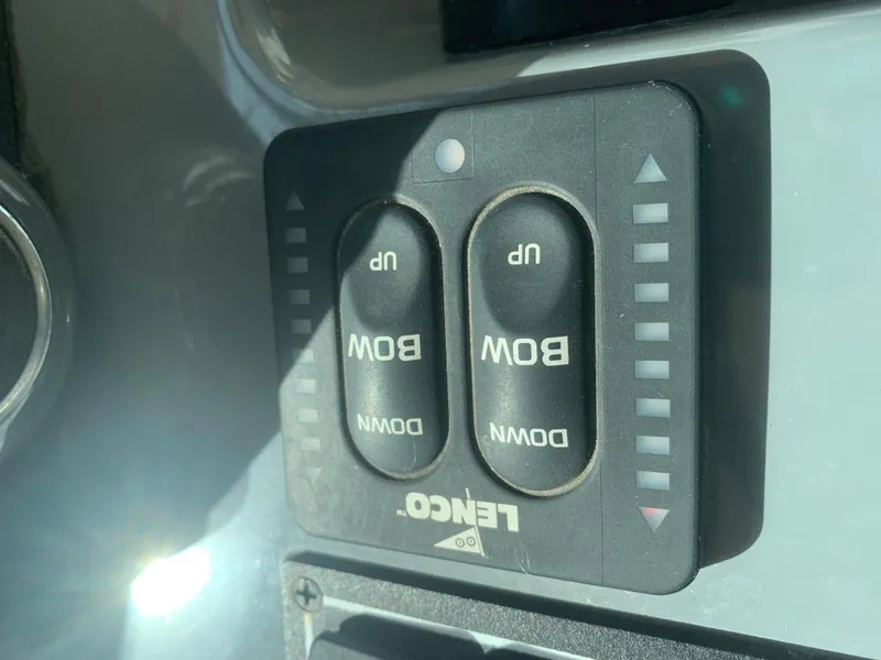 Slide: The Image of Lenco trim tab control panel on 2008 Pursuit 315 OS boat dashboard. - 9