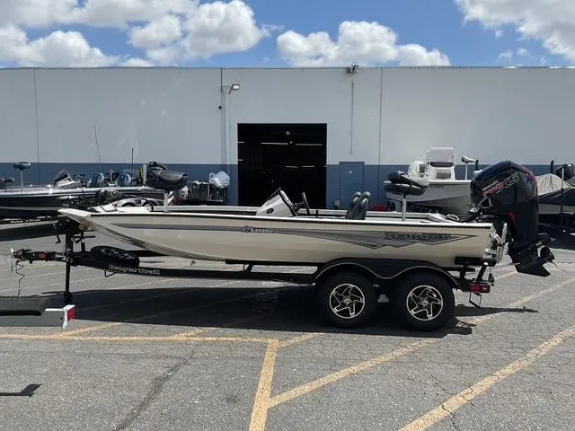 Slide: The Image of 2025 Ranger RT188P boat on trailer, parked outdoors under a cloudy sky. - 1