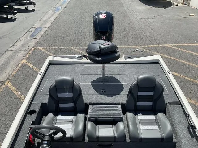 Slide: The Image of 2025 Ranger RT188P boat interior with dual seats and steering wheel, parked on asphalt. - 11