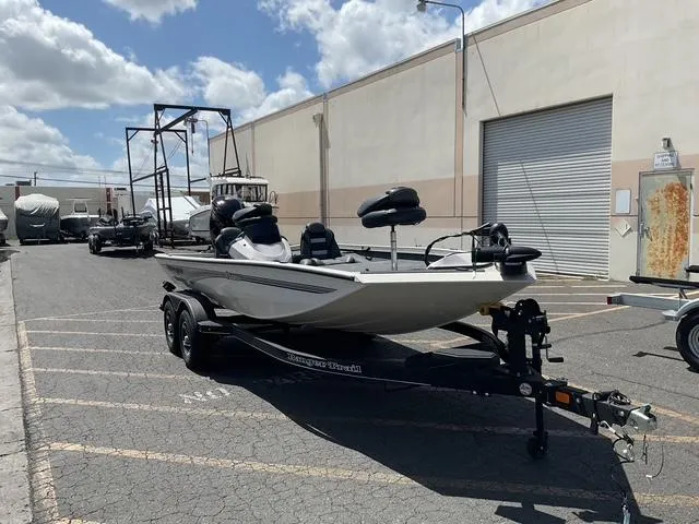 Slide: The Image of 2025 Ranger RT188P boat on trailer in industrial parking lot. - 2
