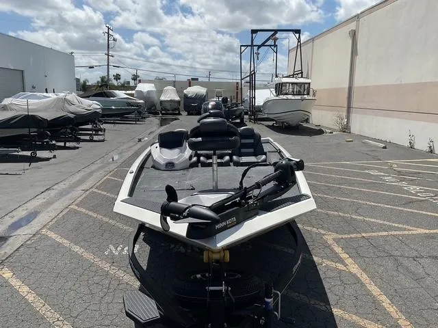Slide: The Image of 2025 Ranger RT188P boat in a storage lot under a partly cloudy sky. - 5