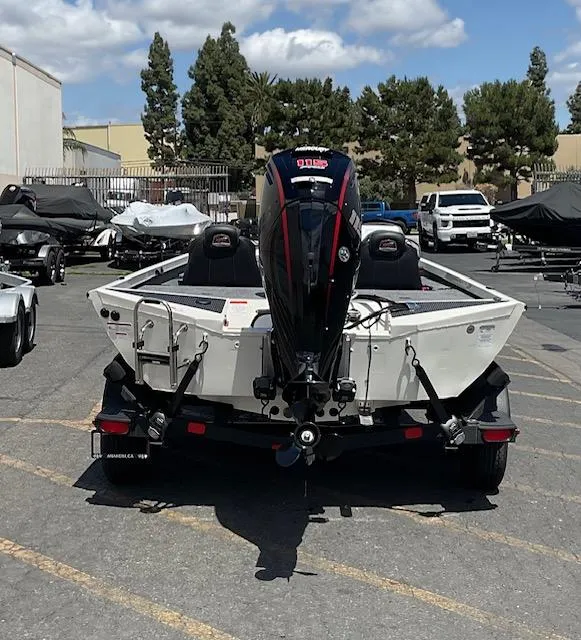 Slide: The Image of 2025 Ranger RT188P boat in a parking lot, rear view with motor, under a clear sky. - 8