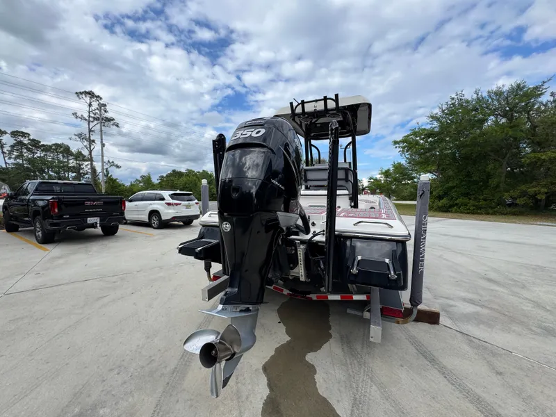 Slide: The Image of 2018 ShearWater 260 Carolina Flare boat on trailer, featuring powerful outboard motor. - 13