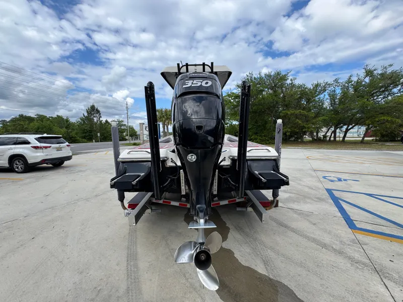 Slide: The Image of 2018 ShearWater 260 Carolina Flare boat with powerful outboard motor, parked on a trailer. - 14