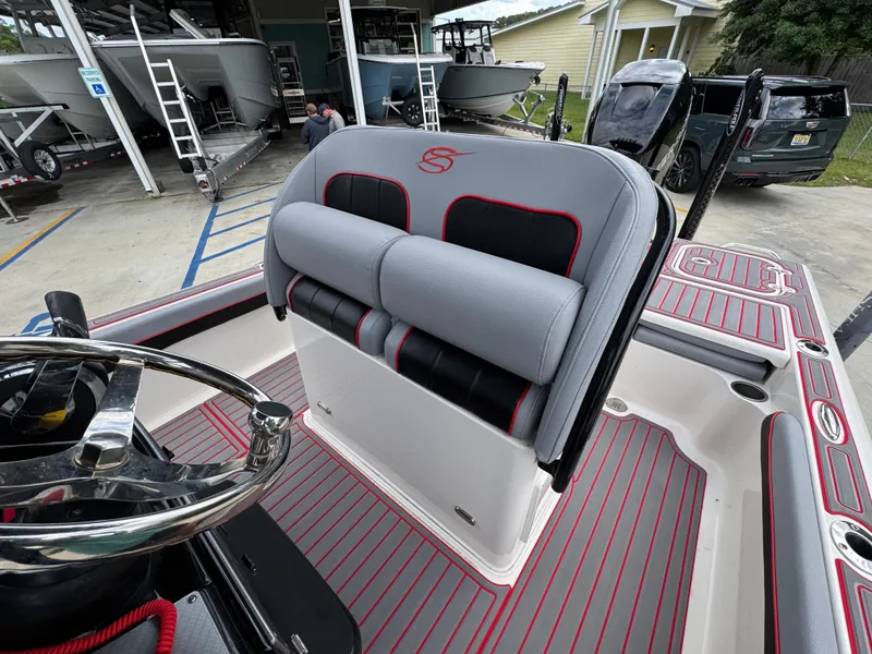 Slide: The Image of 2018 ShearWater 260 Carolina Flare boat interior with gray and red seating. - 22