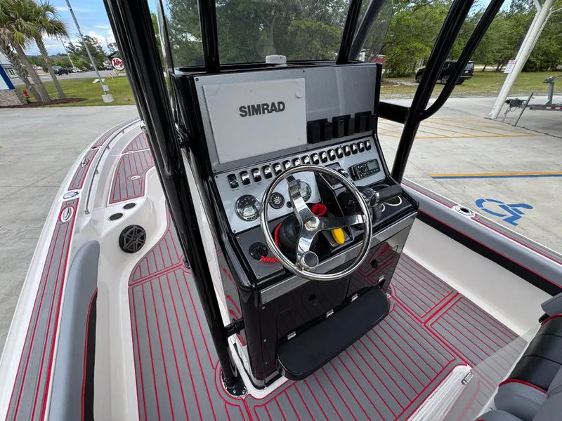 Slide: The Image of 2018 ShearWater 260 Carolina Flare boat console with Simrad electronics and stylish red-striped flooring. - 24