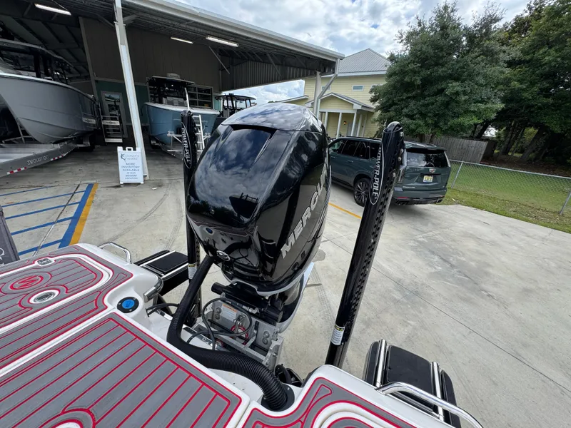 Slide: The Image of 2018 ShearWater 260 Carolina Flare boat with powerful outboard motor in a marina setting. - 31