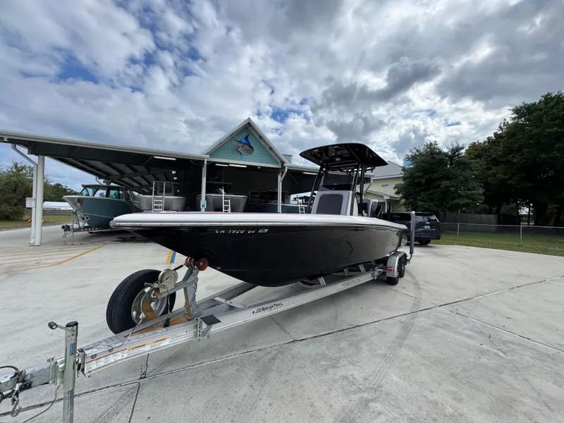 Slide: The Image of 2018 ShearWater 260 Carolina Flare boat on trailer, parked outdoors under cloudy sky. - 4