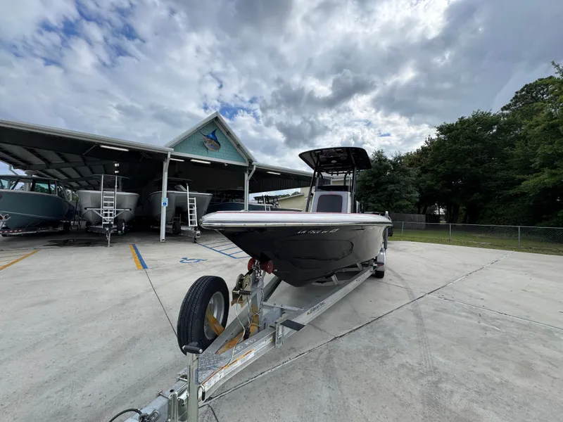 Slide: The Image of 2018 ShearWater 260 Carolina Flare boat on trailer under cloudy sky. - 5