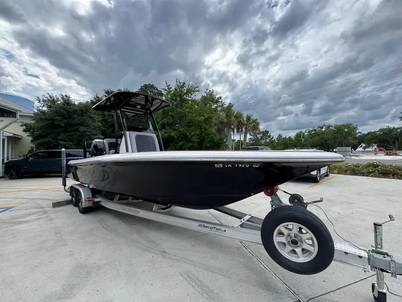 Slide: The Image of 2018 ShearWater 260 Carolina Flare boat on trailer under cloudy sky. - 7