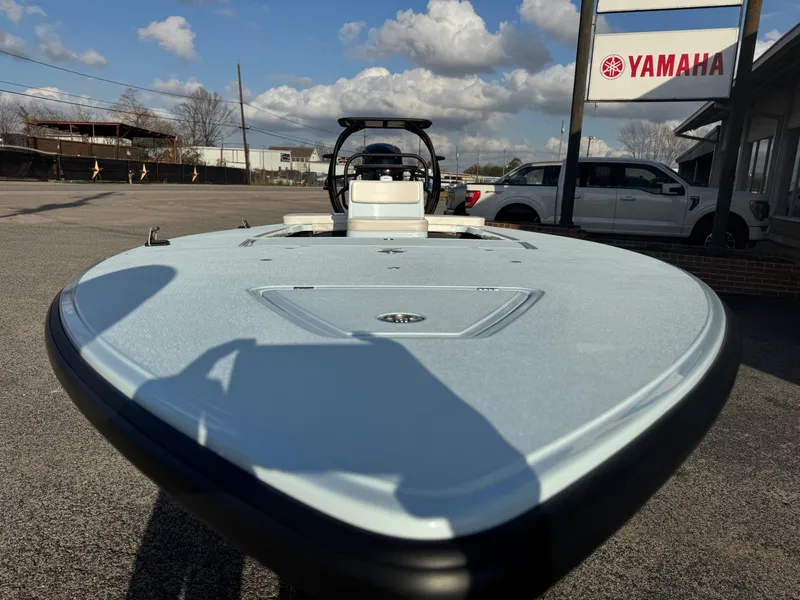 Slide: The Image of 2024 Chittum Skiffs 21 Mangrove boat at Yamaha dealership, clear sky background. - 11