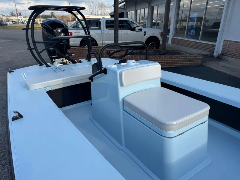 Slide: The Image of 2024 Chittum Skiffs 21 Mangrove boat with center console and outboard motor. - 12