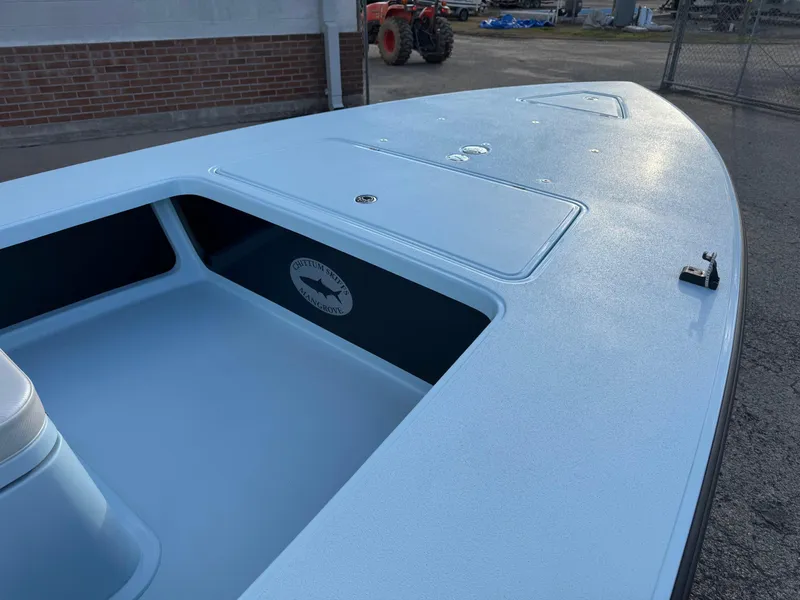 Slide: The Image of 2024 Chittum Skiffs 21 Mangrove boat deck, featuring storage compartments and sleek design. - 14