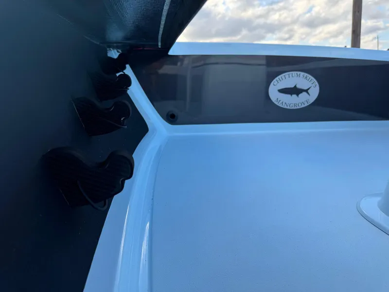 Slide: The Image of 2024 Chittum Skiffs 21 Mangrove boat interior with logo and rod holders. - 16
