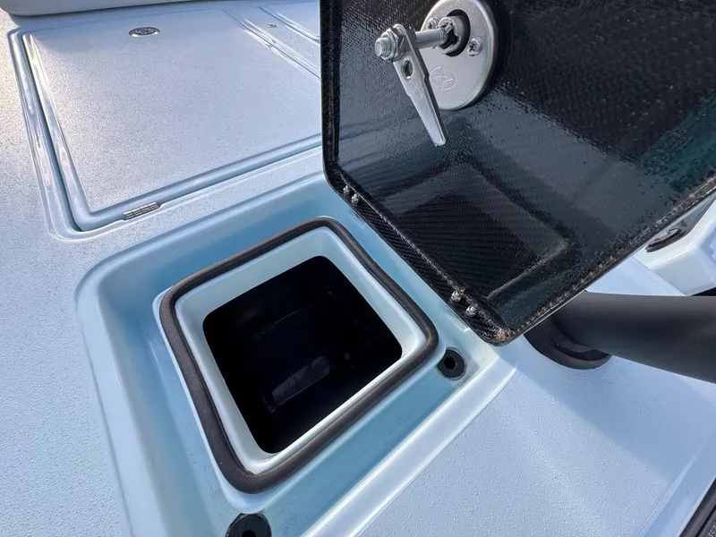 Slide: The Image of 2024 Chittum Skiffs 21 Mangrove boat hatch detail, showcasing open storage compartment. - 19