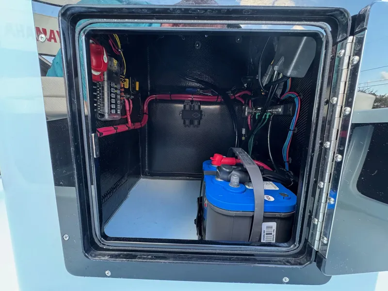 Slide: The Image of 2024 Chittum Skiffs 21 Mangrove battery compartment with wiring and components. - 20