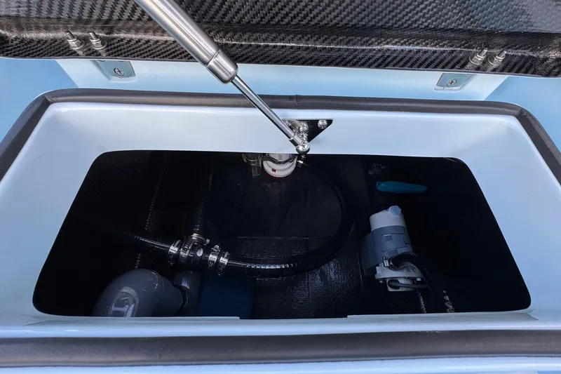 Slide: The Image of 2024 Chittum Skiffs 21 Mangrove storage compartment with hydraulic lift and internal components. - 24