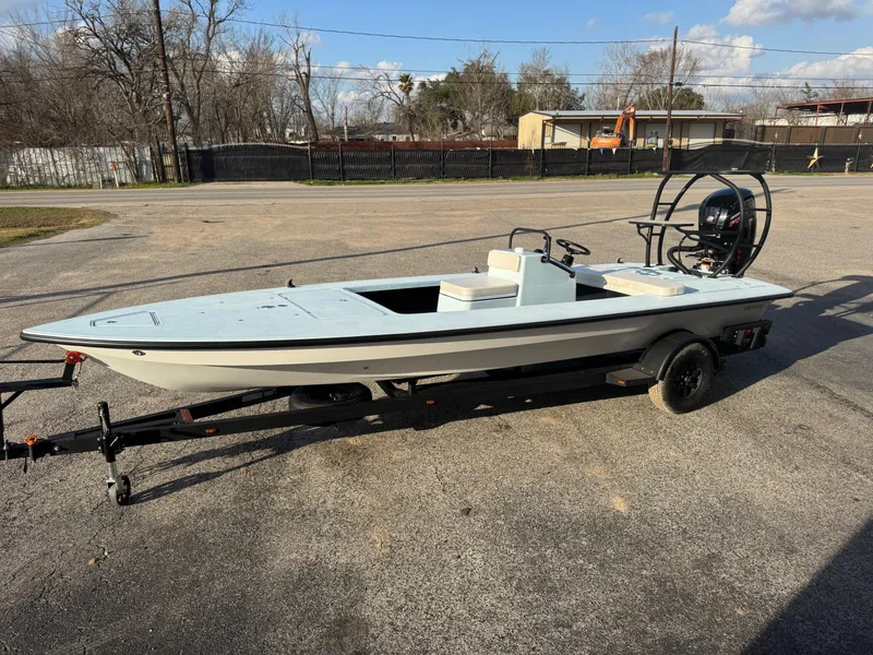 Slide: The Image of 2024 Chittum Skiffs 21 Mangrove boat on trailer in parking lot. - 7