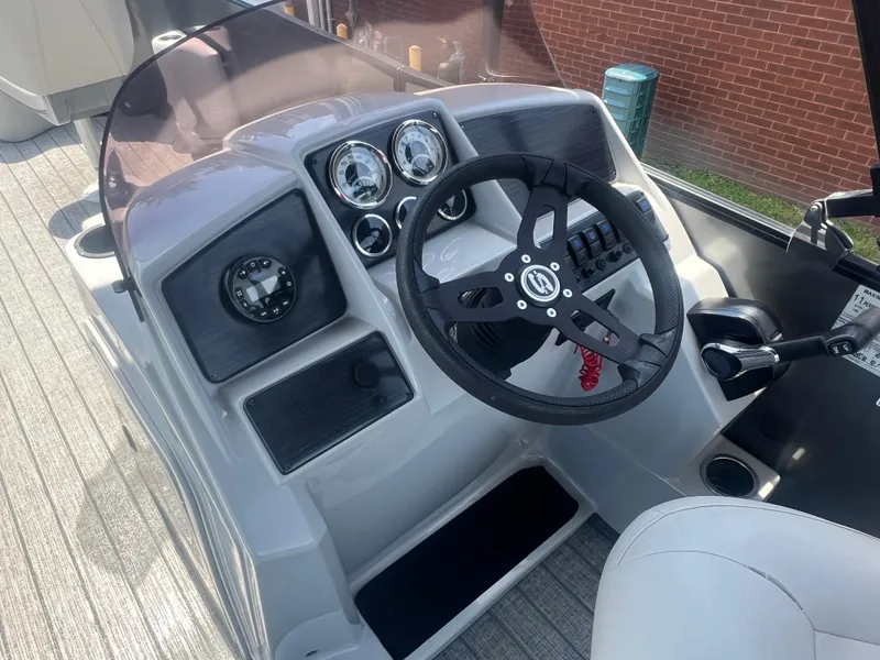 Slide: The Image of 2021 Sylvan Mirage Fish 8522 Party Fish 4.0 boat dashboard with steering wheel and gauges. - 16