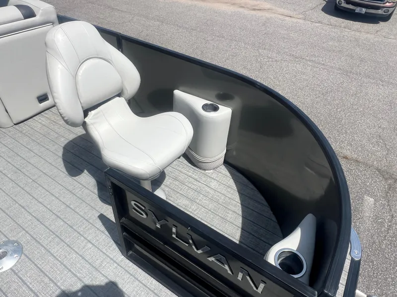Slide: The Image of 2021 Sylvan Mirage Fish 8522 Party Fish 4.0 boat interior with seating and cup holders. - 21