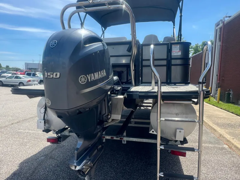 Slide: The Image of 2021 Sylvan Mirage Fish 8522 Party Fish 4.0 with Yamaha 150 engine, parked outdoors. - 8