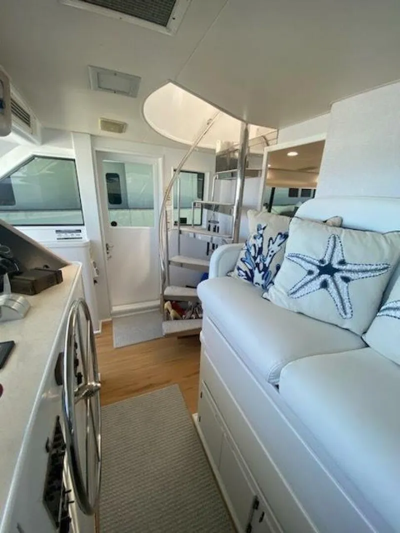 Slide: The Image of Interior of 1989 Hatteras Custom Cockpit yacht with spiral staircase and nautical decor. - 14