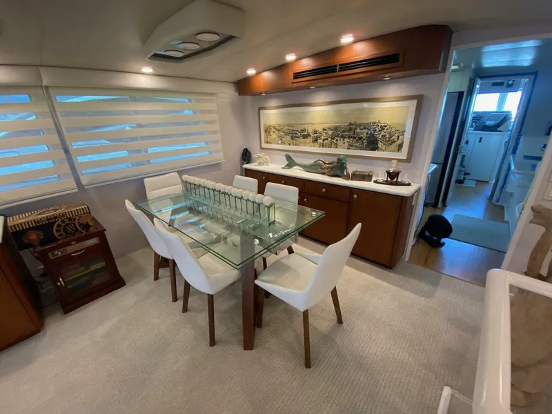 Slide: The Image of Luxurious interior of 1989 Hatteras Custom Cockpit yacht with elegant dining area. - 17