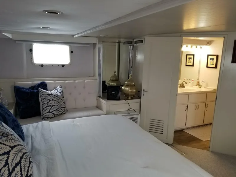 Slide: The Image of 1989 Hatteras Custom Cockpit interior with cozy bedroom and ensuite bathroom. - 23