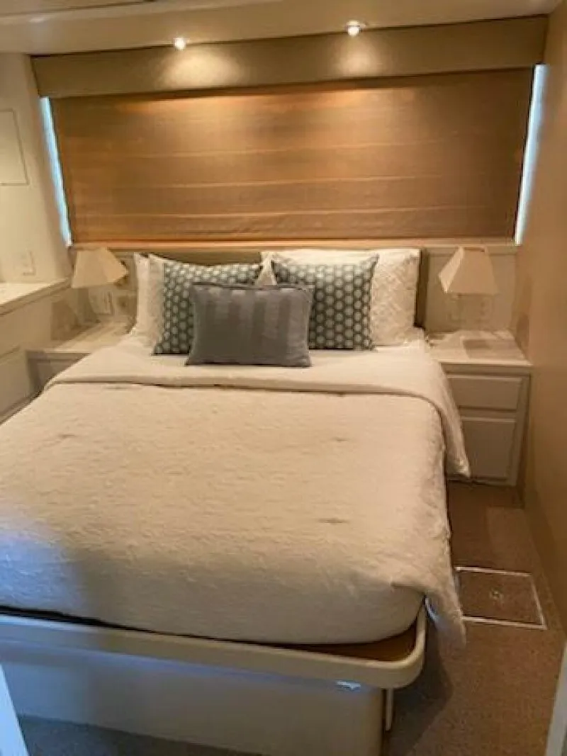 Slide: The Image of 1989 Hatteras Custom Cockpit bedroom with cozy bedding and soft lighting. - 25