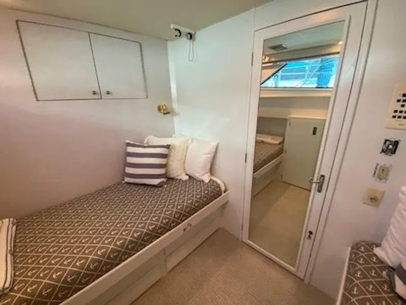 Slide: The Image of 1989 Hatteras Custom Cockpit cabin interior with cozy bed and modern decor. - 29
