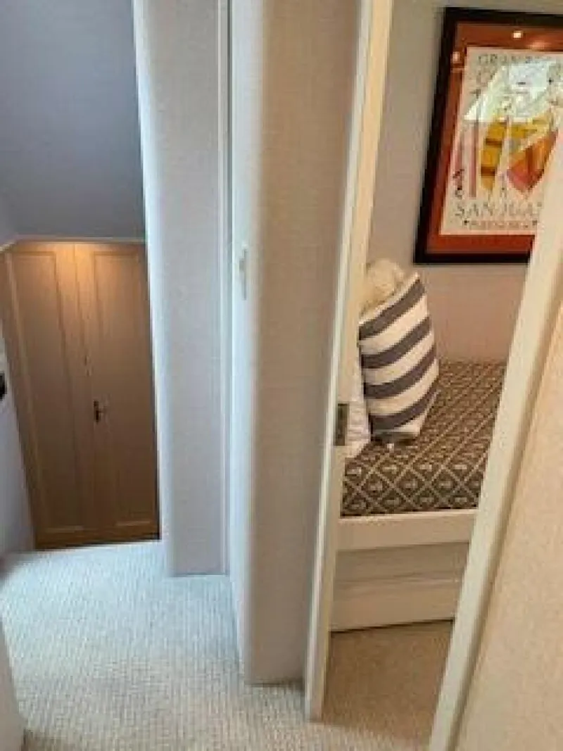 Slide: The Image of 1989 Hatteras Custom Cockpit interior with cozy bedroom and striped pillow. - 31