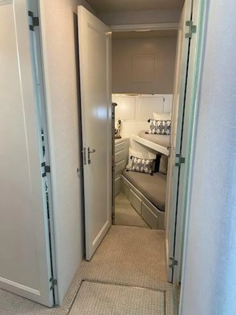 Slide: The Image of 1989 Hatteras Custom Cockpit interior with cozy bunk beds and modern decor. - 32