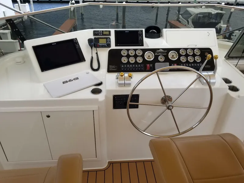 Slide: The Image of 1989 Hatteras Custom Cockpit with modern navigation equipment and classic steering wheel. - 5