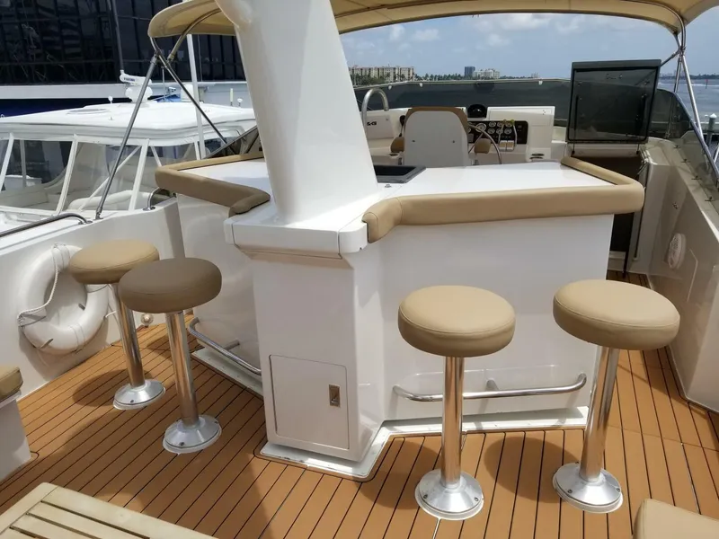Slide: The Image of 1989 Hatteras Custom Cockpit yacht with bar stools and teak deck, docked in a marina. - 7