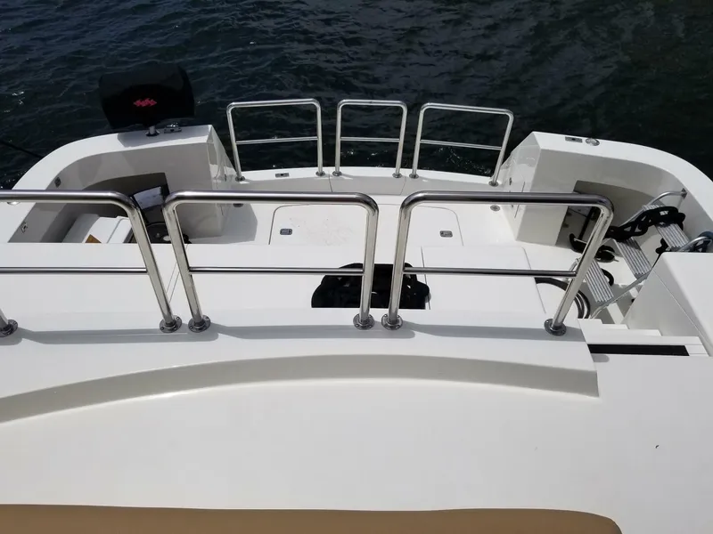 Slide: The Image of 1989 Hatteras Custom Cockpit boat with sleek white deck and stainless steel railings. - 9