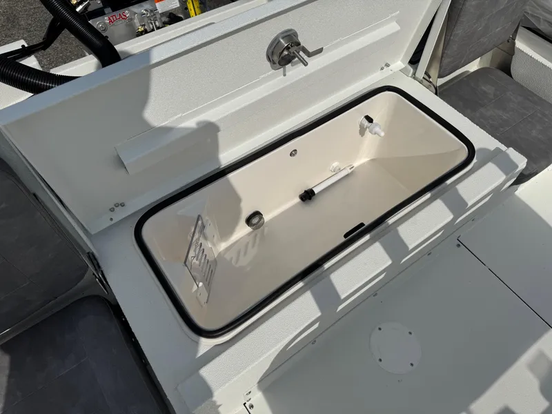 Slide: The Image of Open storage compartment on 2025 Avid 23 Fusion boat, featuring a sleek design. - 11