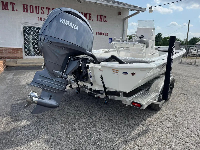 Slide: The Image of 2025 Avid 23 Fusion boat with Yamaha motor on trailer, parked outside a building. - 3