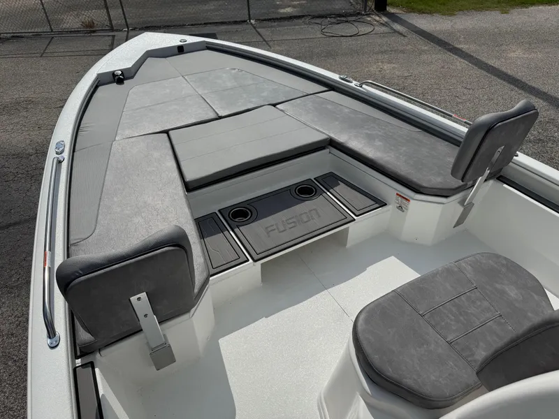 Slide: The Image of 2025 Avid 23 Fusion boat interior with gray seating and storage compartments. - 6