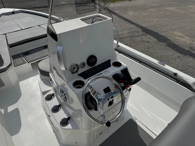 Slide: The Image of 2025 Avid 23 Fusion boat cockpit with steering wheel and control panel. - 7