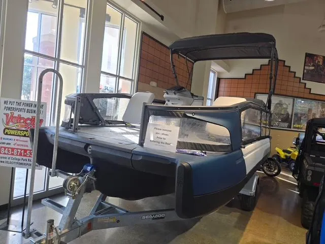 The Image of 2024 Sea-Doo Switch Sport 21 boat displayed indoors on a trailer. - 0