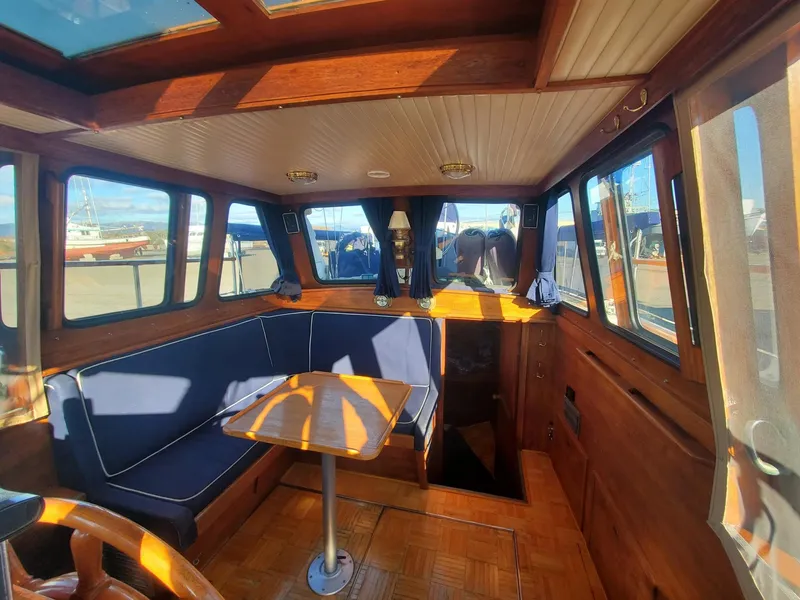 Slide: The Image of Interior of 1982 Nauticat 38 sailboat with wooden finish and blue seating. - 5