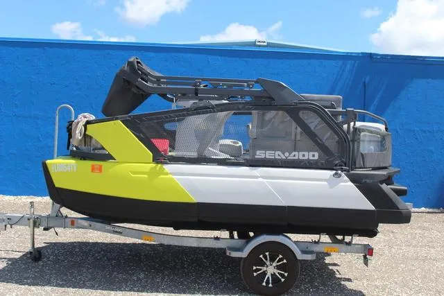 Slide: The Image of 2024 Sea-Doo Switch® Cruise 18 - 170 hp on trailer, vibrant design, blue background. - 1