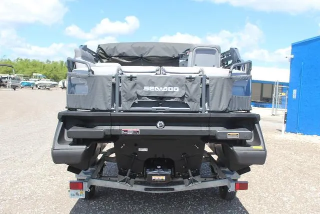 Slide: The Image of 2024 Sea-Doo Switch® Cruise 18 - 170 hp pontoon boat, rear view, parked outdoors. - 5
