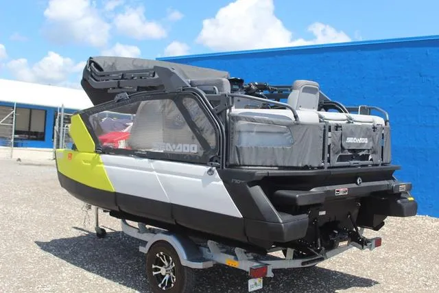 Slide: The Image of 2024 Sea-Doo Switch® Cruise 18 - 170 hp pontoon boat on trailer, parked outdoors. - 6
