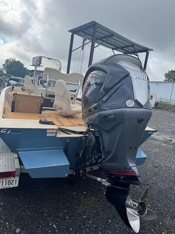 Slide: The Image of 2022 G3 BAY 22 DELUXE boat with Yamaha outboard motor, parked outdoors. - 14