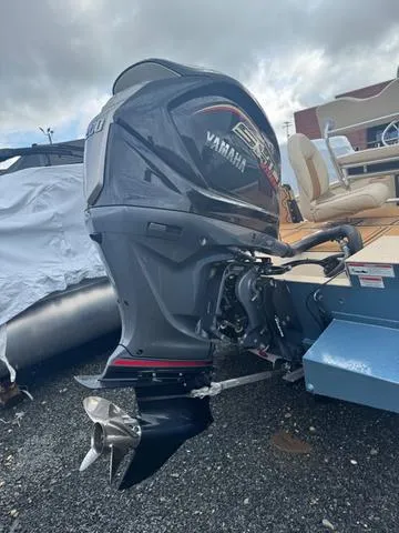 Slide: The Image of 2022 G3 BAY 22 DELUXE boat with Yamaha outboard motor, parked on gravel. - 15