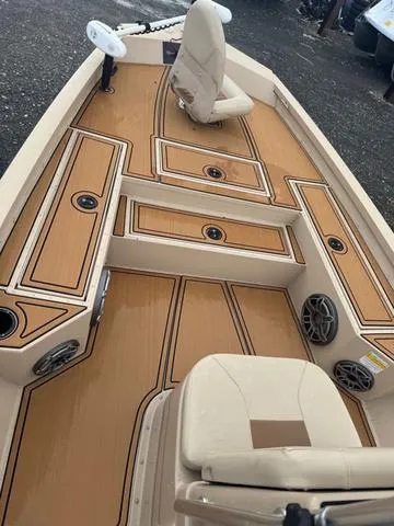 Slide: The Image of 2022 G3 BAY 22 DELUXE boat interior with tan seating and storage compartments. - 3