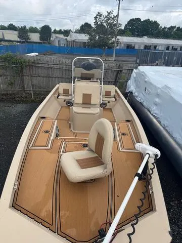 Slide: The Image of 2022 G3 BAY 22 DELUXE boat with tan seating and deck, parked outdoors. - 4