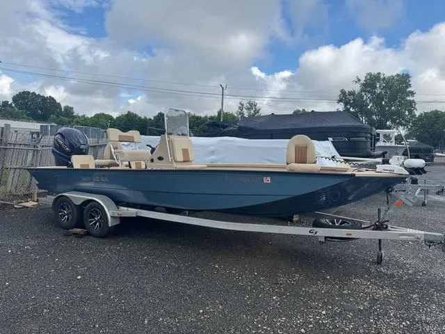 Slide: The Image of 2022 G3 BAY 22 DELUXE boat on trailer, parked outdoors under cloudy sky. - 5